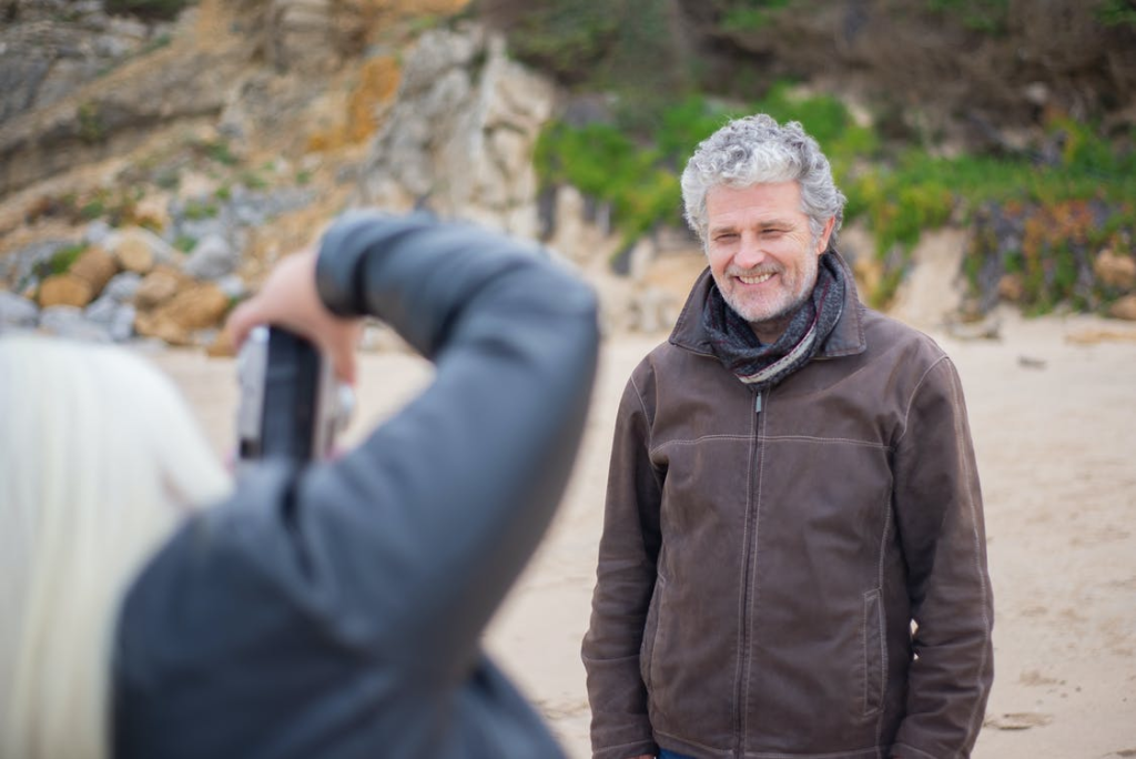 An elderly person being photographed