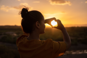 a person making a heart with their hands