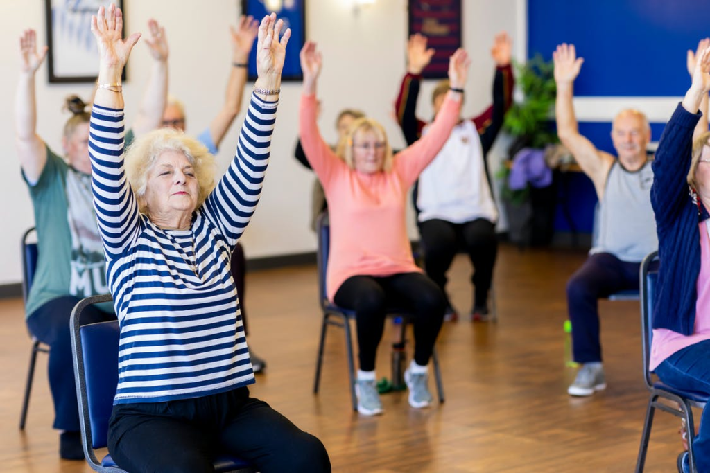 A group of seniors doing stretches together.