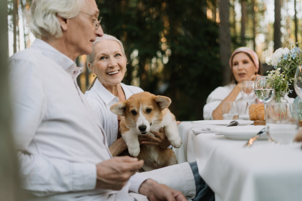 A senior holding up their dog.