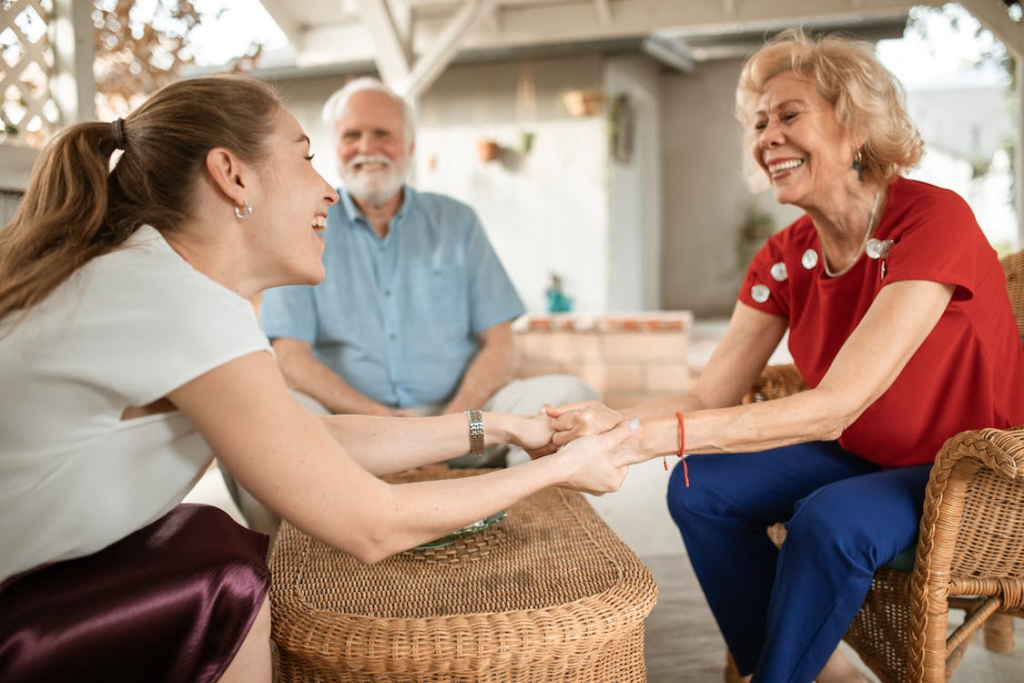 A person holding their parent’s hands