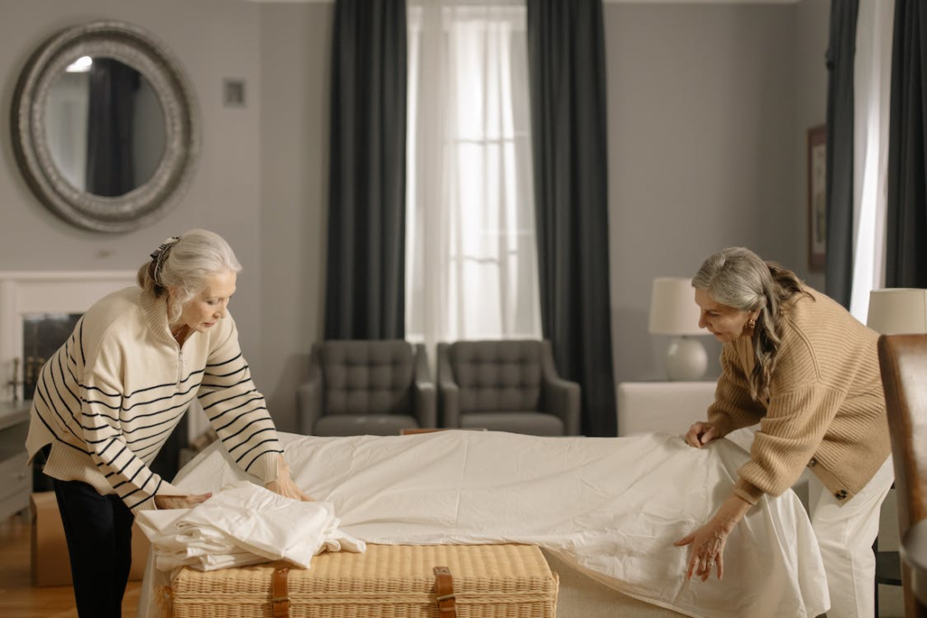 Two senior people packing furniture for moving.