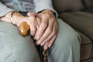 A close up of a person’s wrinkled hands