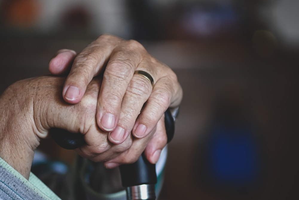  A senior adult holding a walking cane.