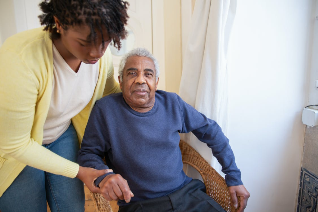 A senior being helped by a nurse.