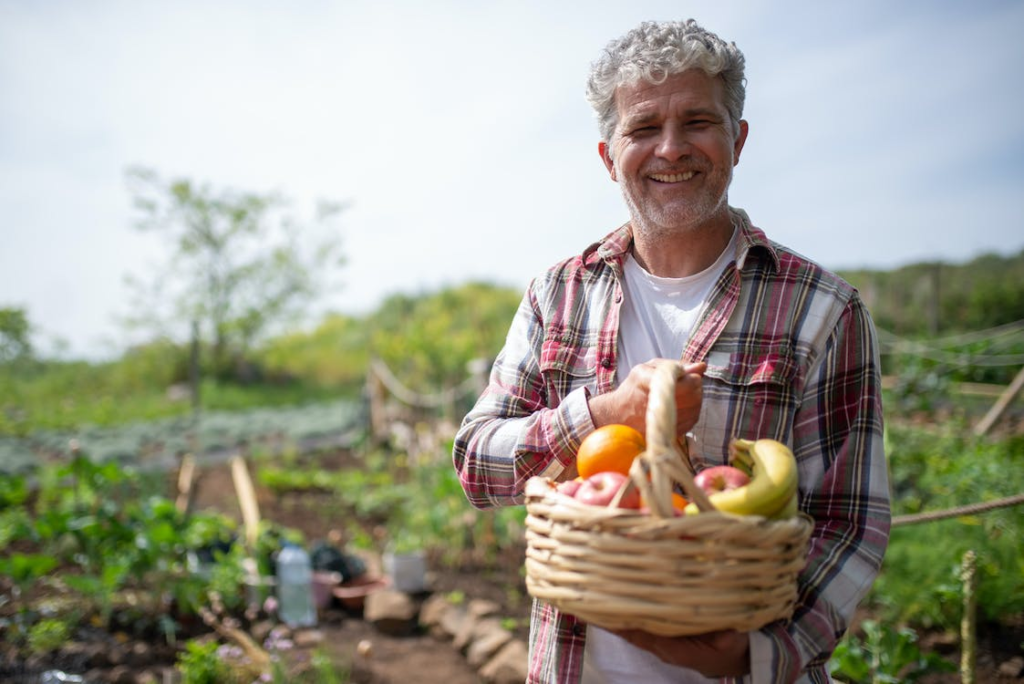 A senior holding a fruit basket.