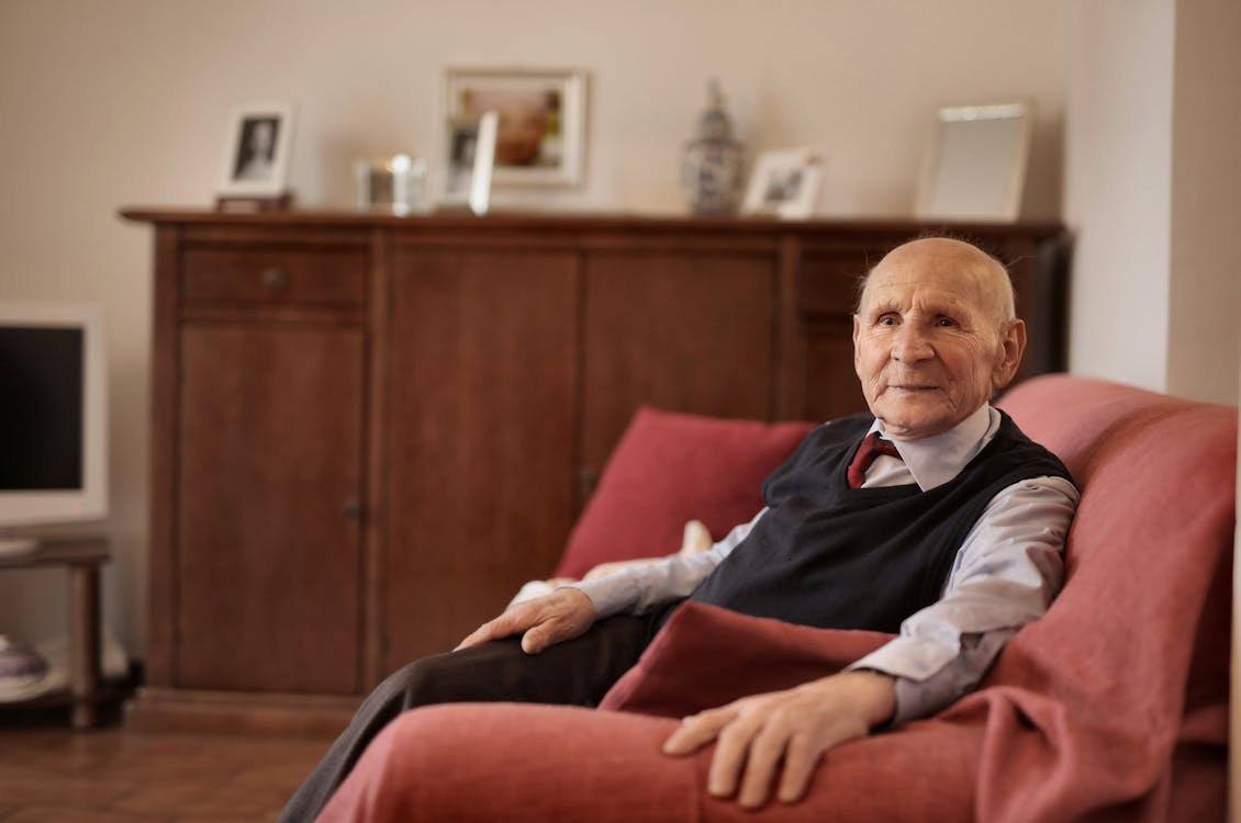 Man Sitting Reading Newspaper