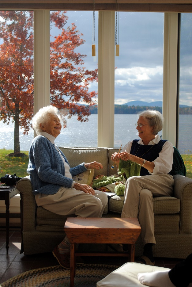 A senior laughing and talking to a friend