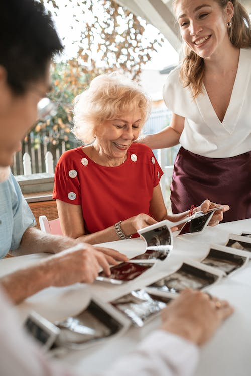 A senior looking at photos with their grandkids