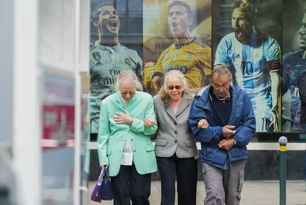 Three elderly adults on a walk.