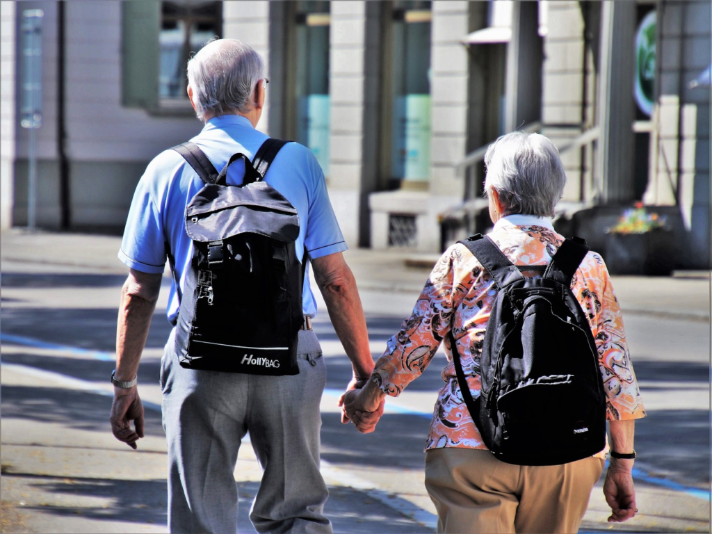  A senior couple holding hands whilewalking