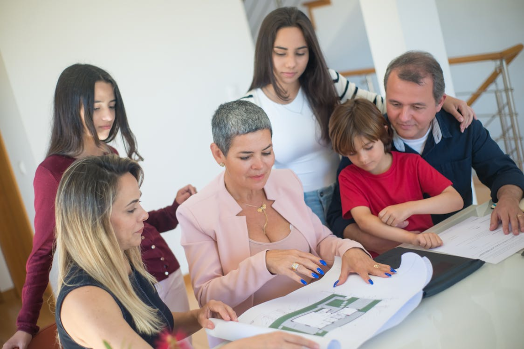 A senior showing a family the layout of a senior living community