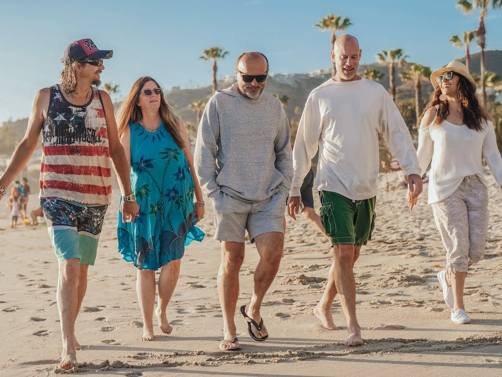 A group of seniorswalking together on a beach