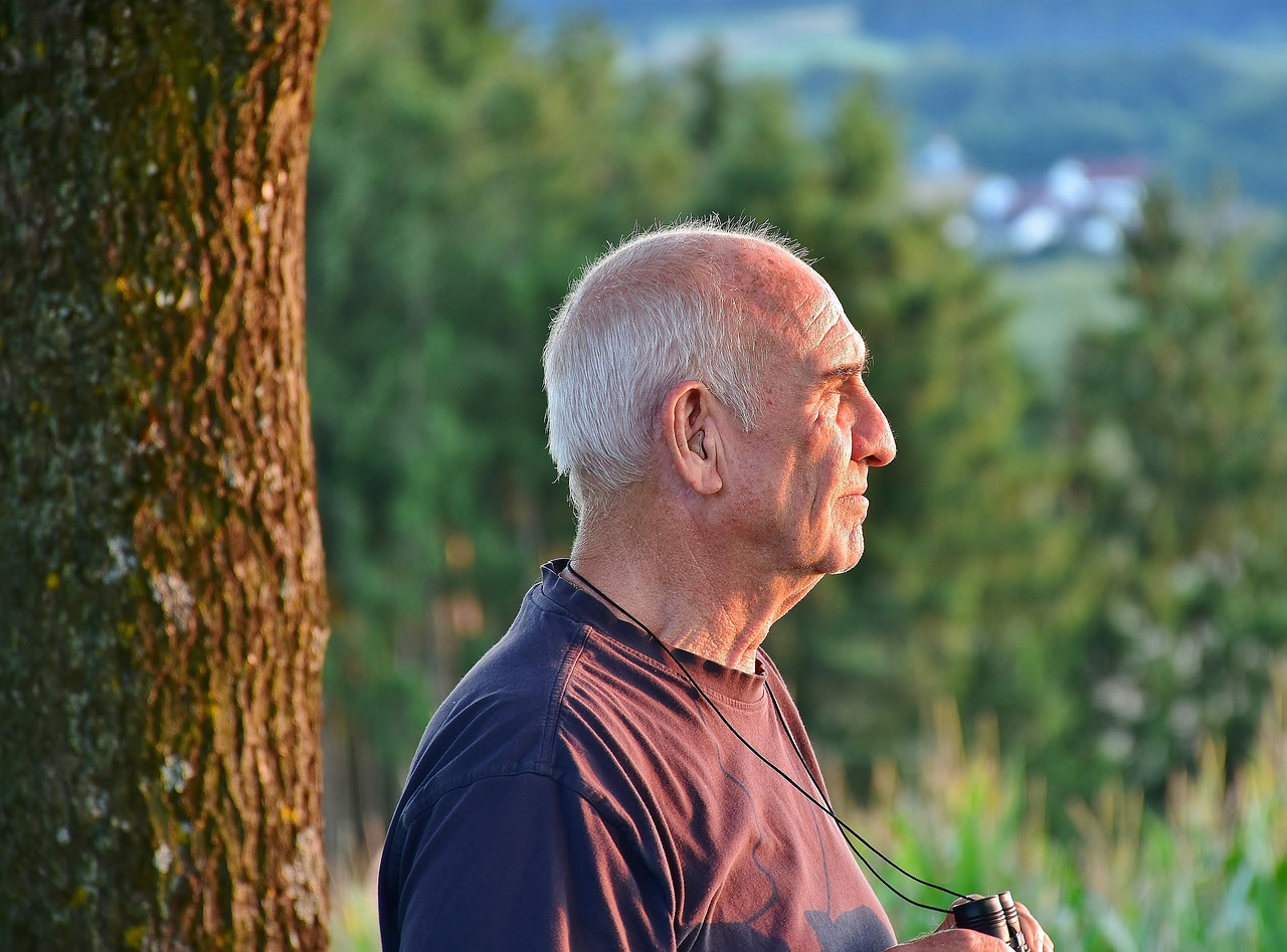 a senior holding binoculars. 