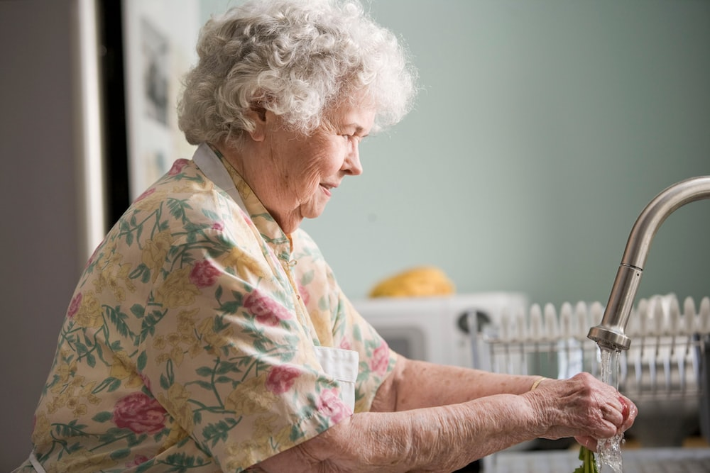 a senior lady washing. 