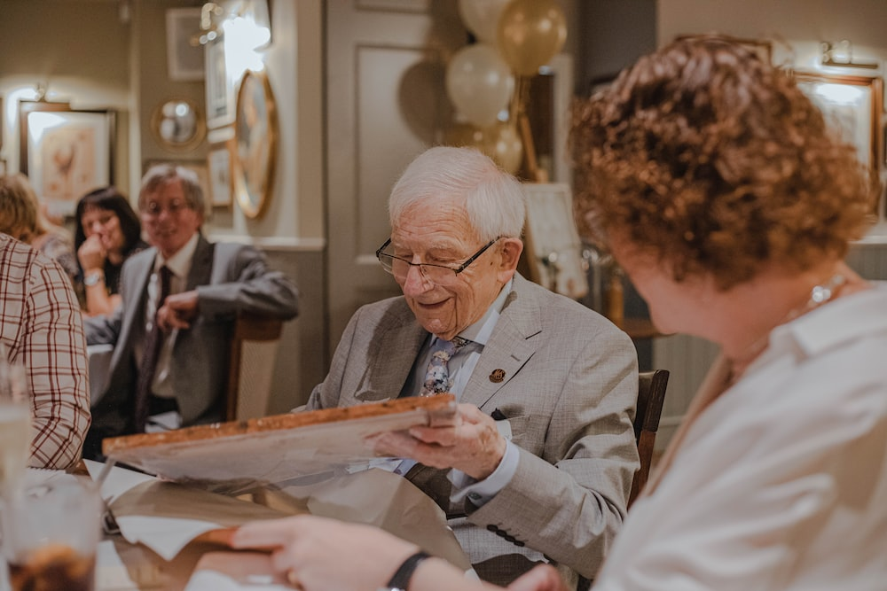 a senior opening a gift.