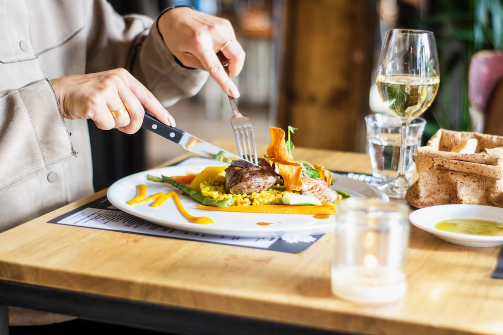  A person slicing into their meal