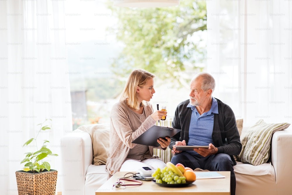 A caregiver helping a senior taking their medication