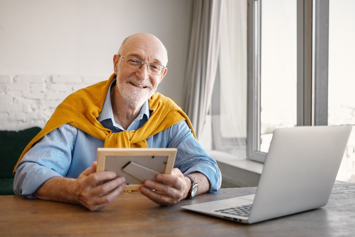 a senior holding a frame