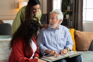 a senior looking at a picture album with relatives