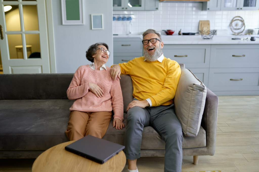 A senior couple laughing and looking at each each other