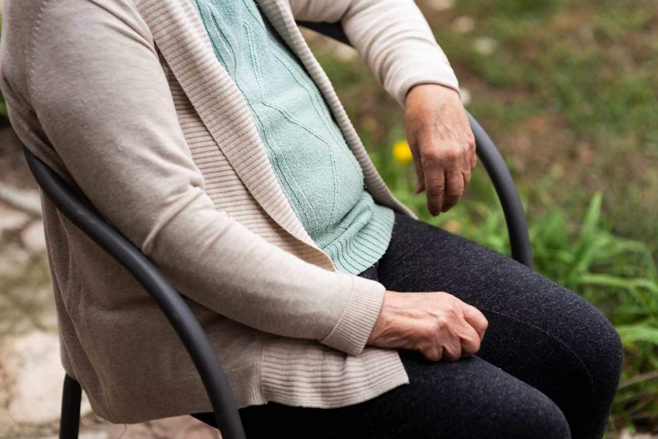 A senior sitting on a chair