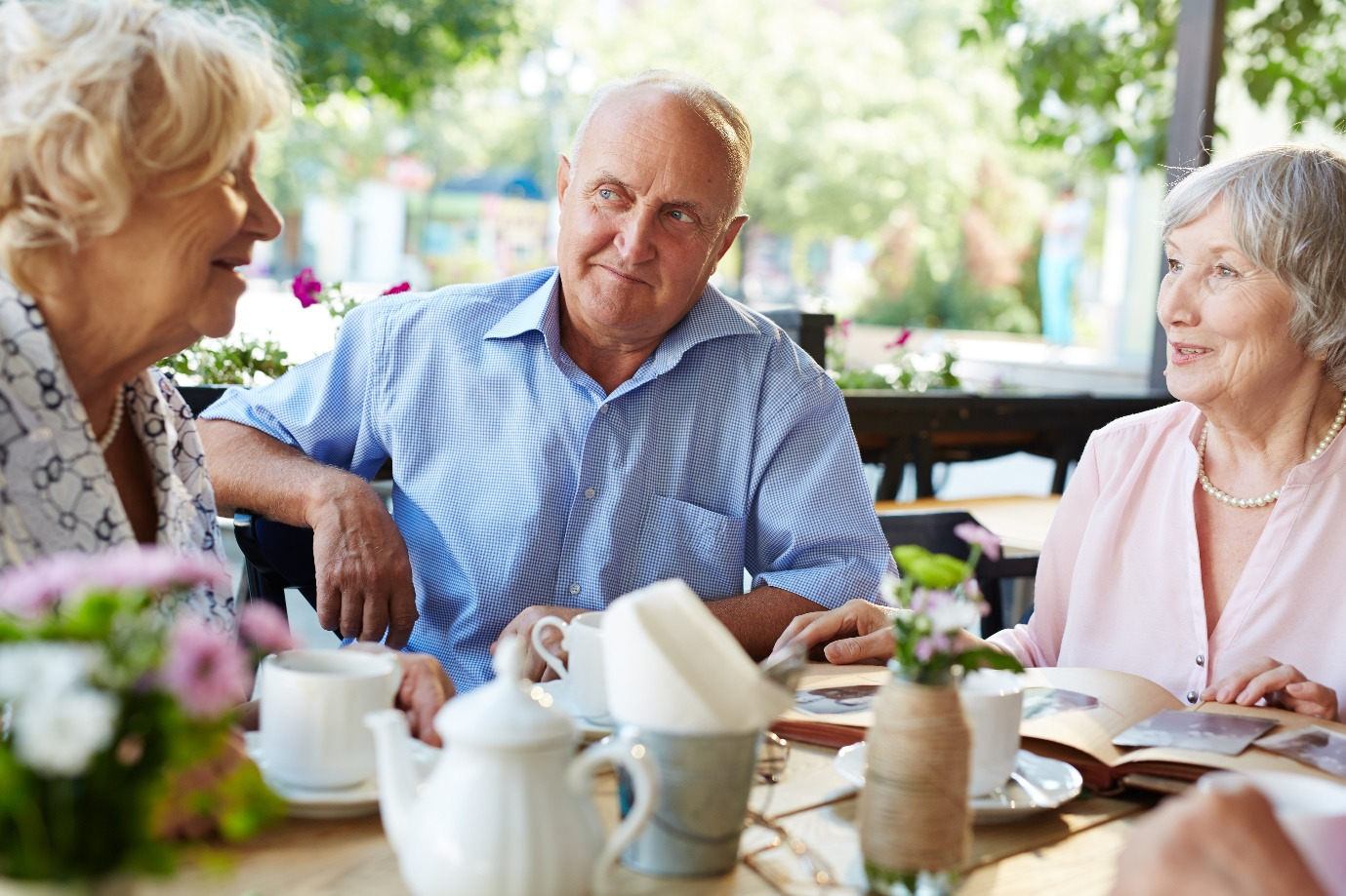 A group of seniors talking over tea