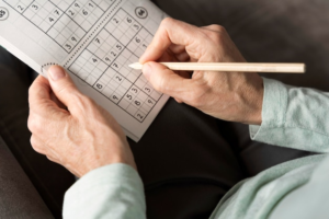 A senior filling out a game of sudoku