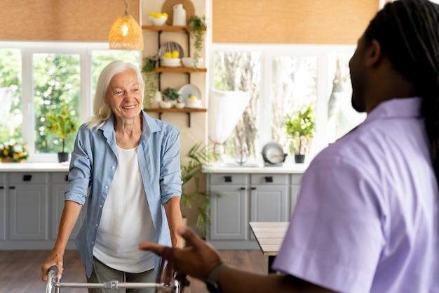 A senior walking towards their caregiver