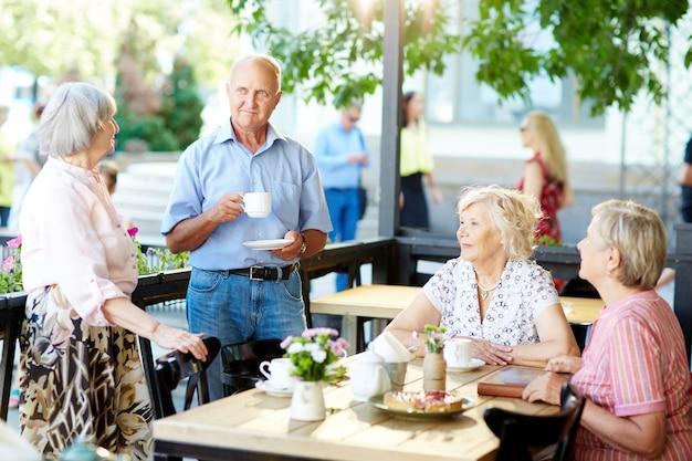 A group of senior friends having tea and conversation