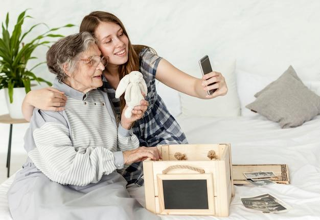 A senior taking a picture with her daughter