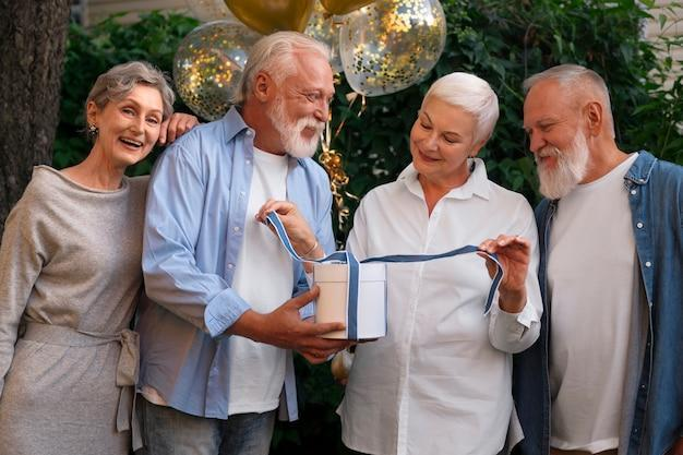 A senior celebrating their birthday with community members