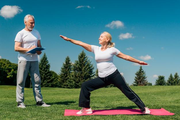 A senior exercising with a professional