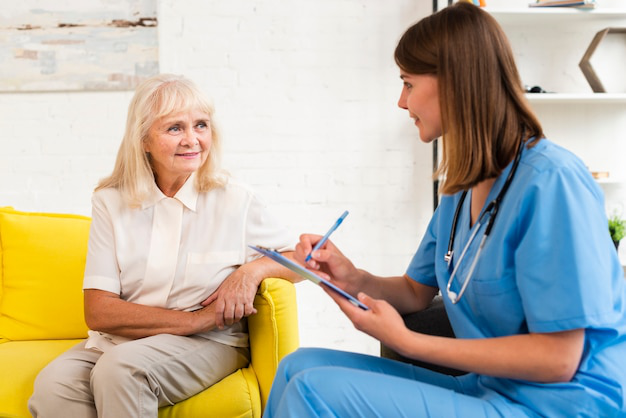 A senior with a caregiver at a memory care community