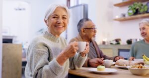 A senior indulging in tea and conversation with friends