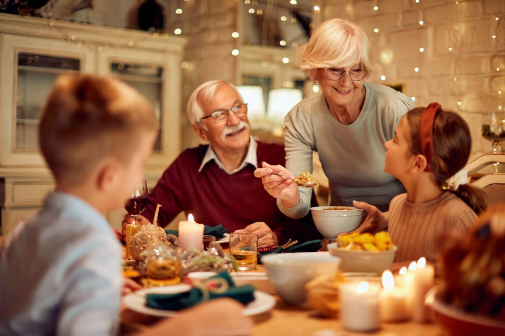 A senior couple having dinner with their family