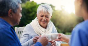 A senior having tea with friends at an assisted living community